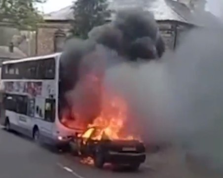 На косъм от трагедия! Горяща кола се заби в училищен автобус