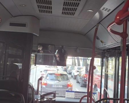 Шофьор на автобус говори по телефона, докато превозва пътници в Пловдив